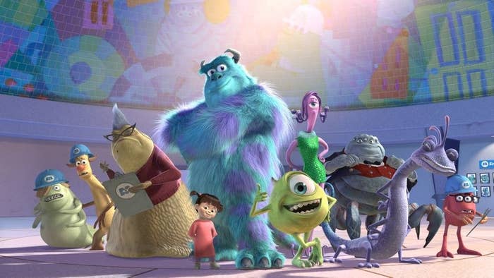 mike wazowski, sully, roz, celia, randall, boo and a few other monsters smile while standing in a line