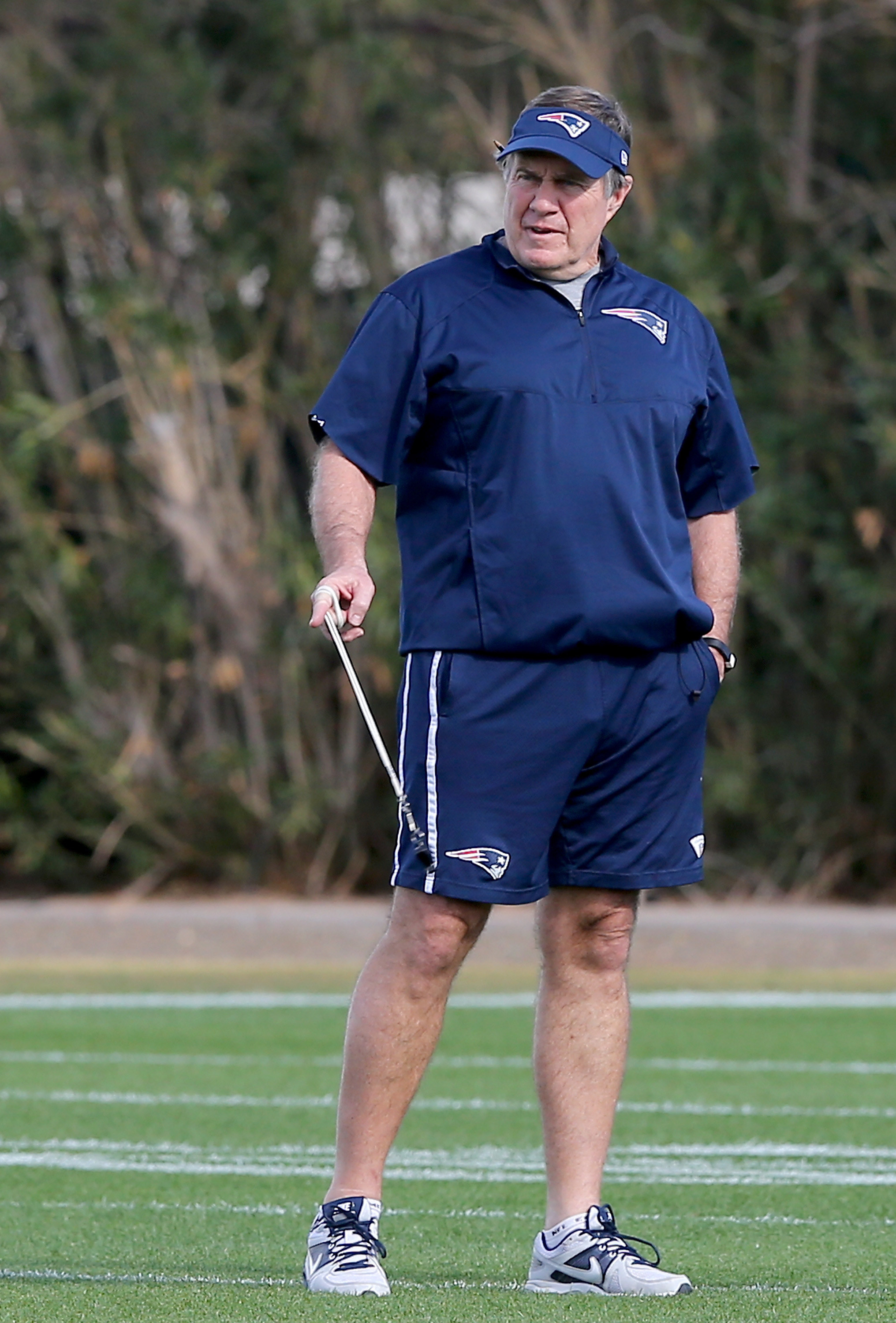 Bill Belichick in a visor and shorts