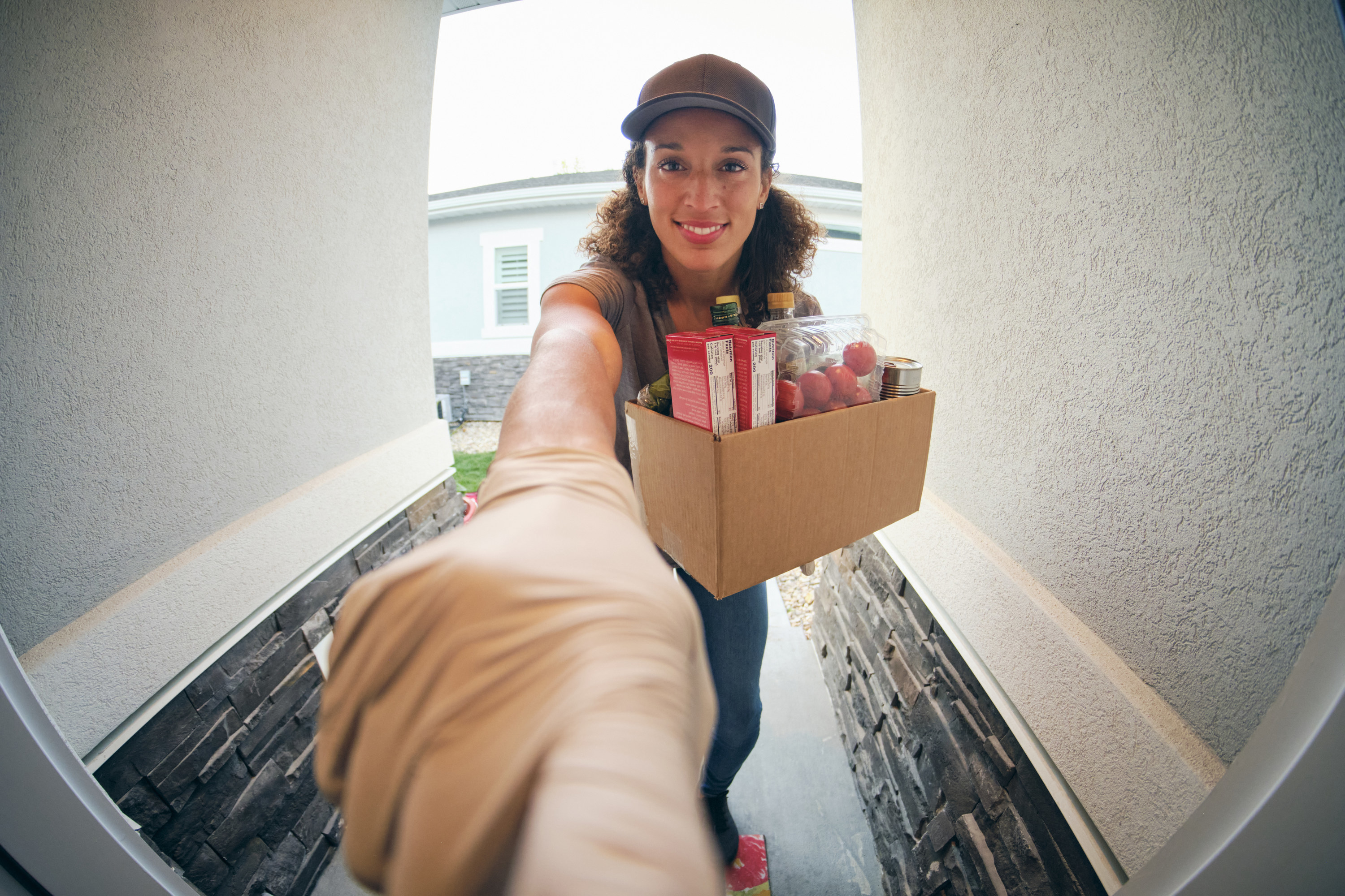 A food delivery person ringing a doorbell
