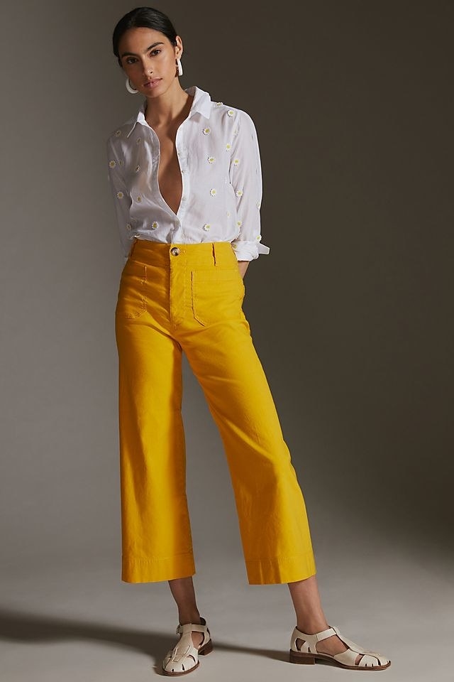 model wearing the bright yellow cropped pants