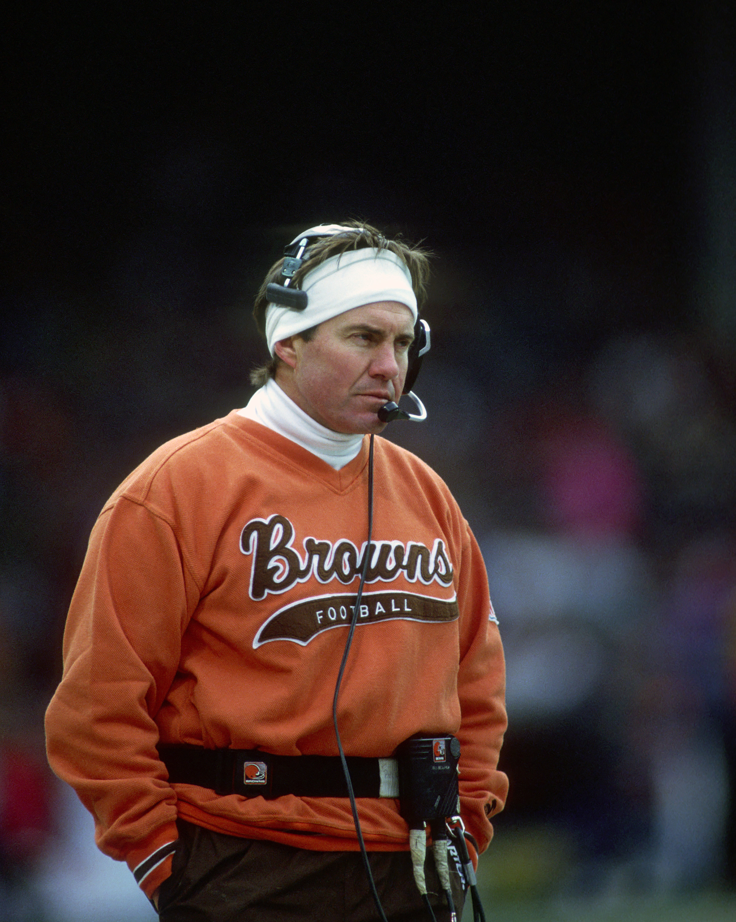 Belichick in an orange sweater