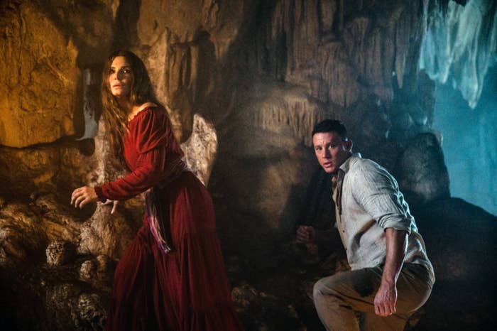 Sandra Bullock and Channing Tatum look for something in a cave