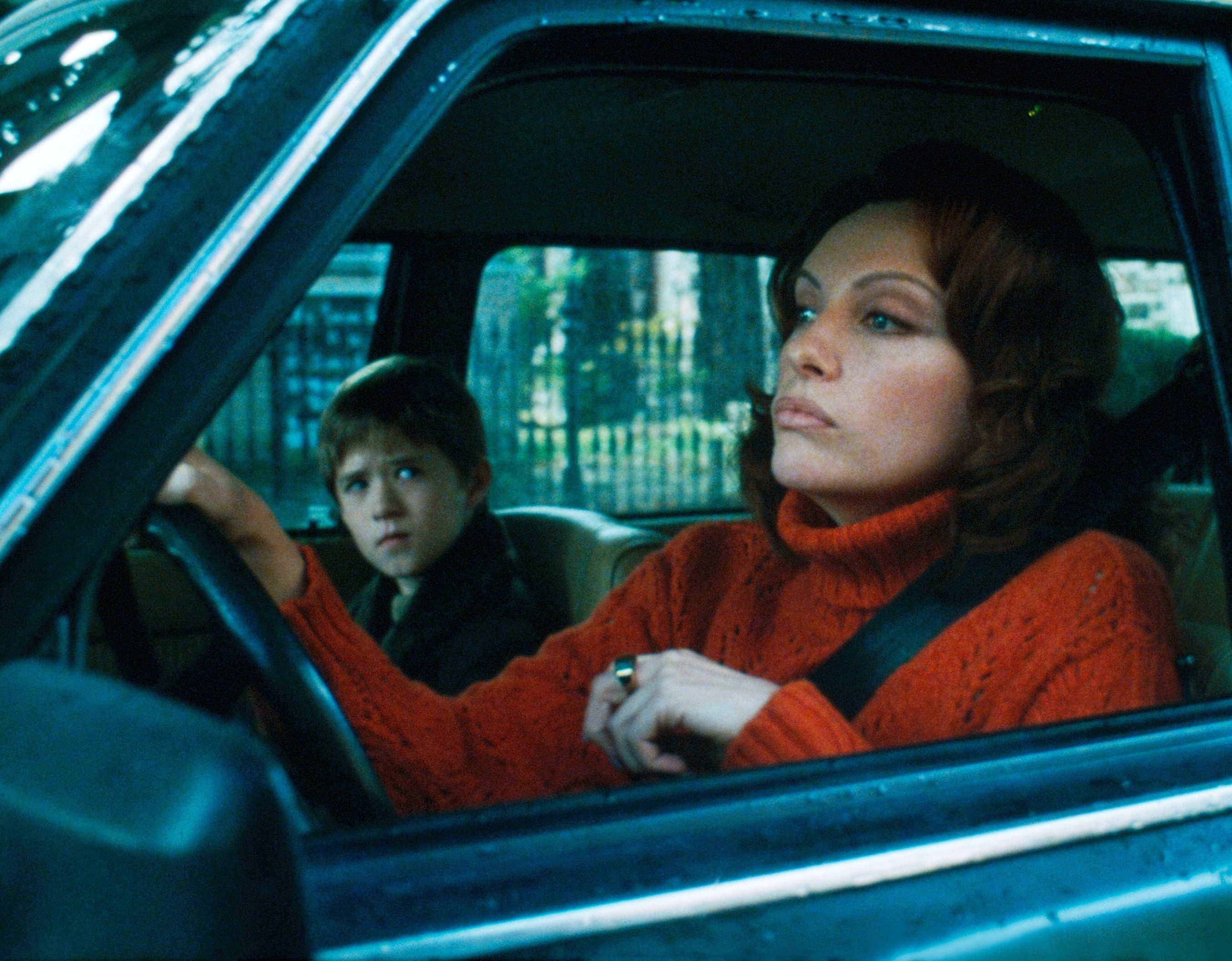 Haley Joel Osment and Toni Collette sit in a car