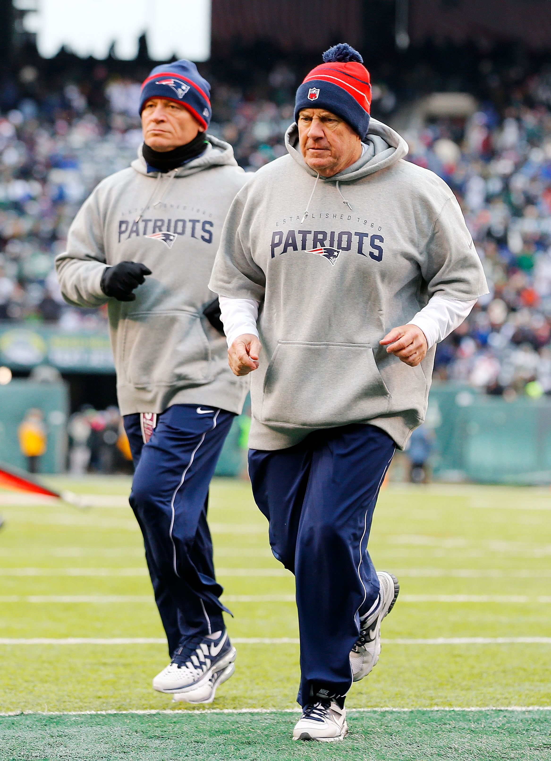 Bill Belichick runs in a hoodie and beanie