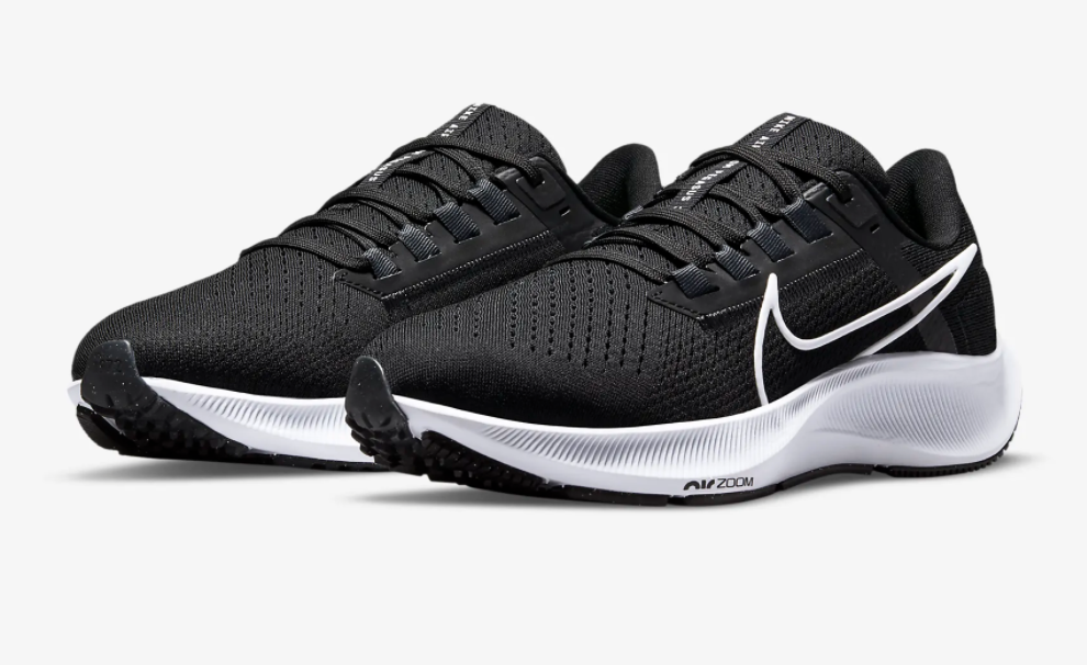 black and white running sneakers with white highlighted Nike logo on the side