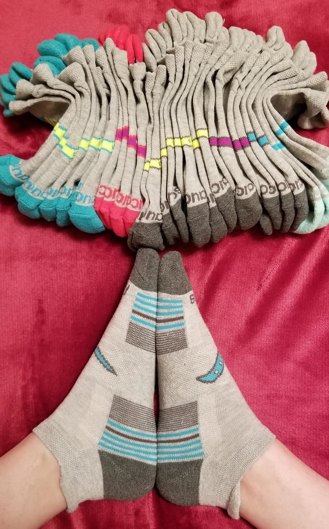 reviewer in gray and blue striped running socks with heel tabs on back