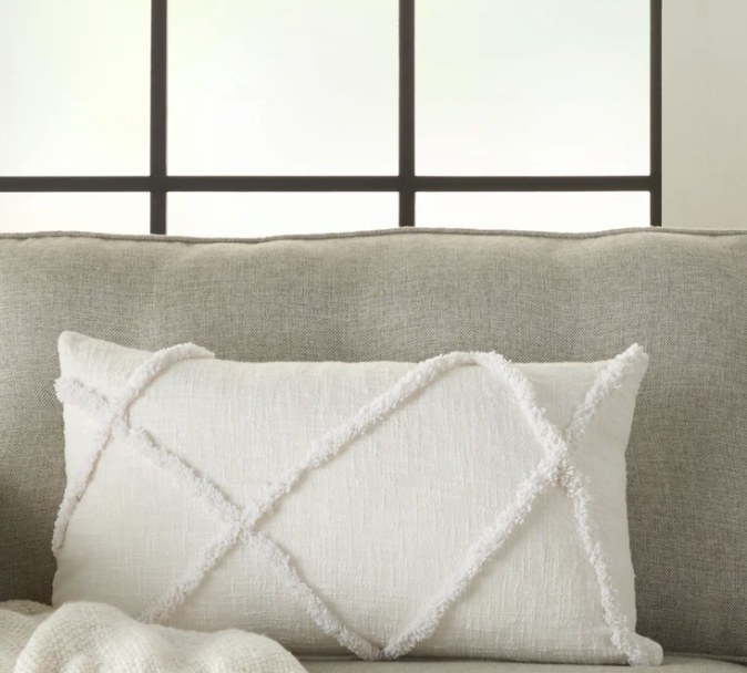 The white pillow has tufted criss-cross edges