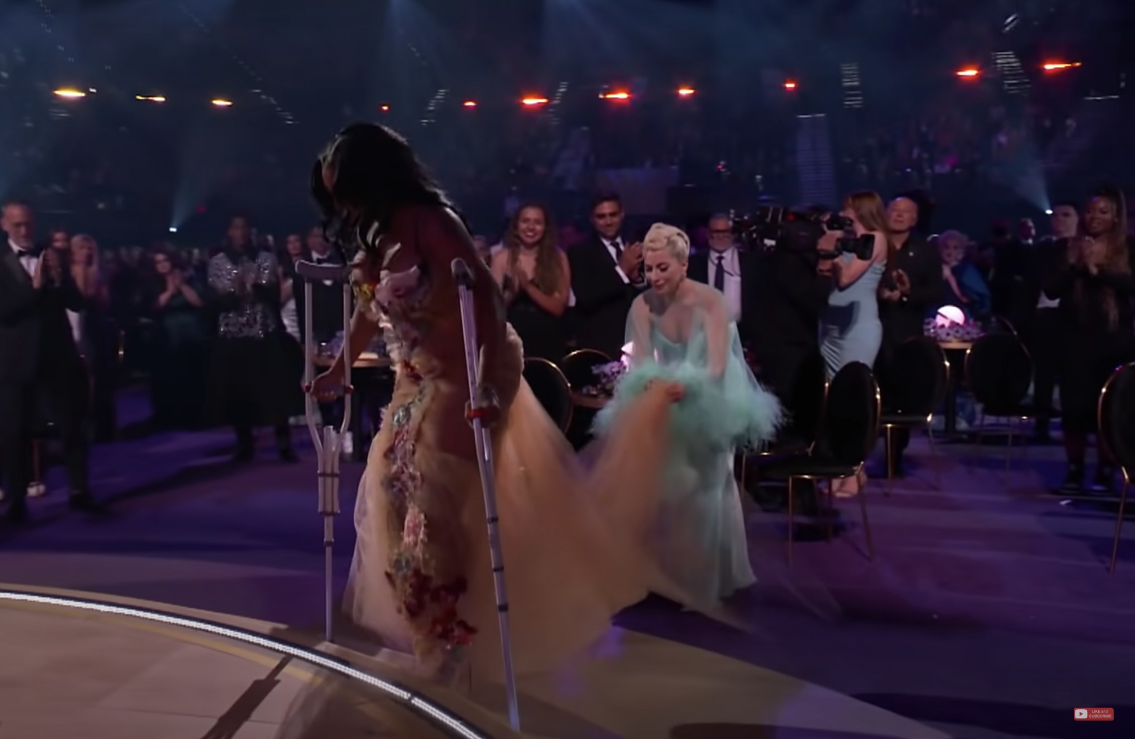 Gaga holds the train of SZA&#x27;s dress while she walks on stage