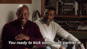A man leans forward on the couch and says, &quot;You ready to kick some butt, partner&quot;