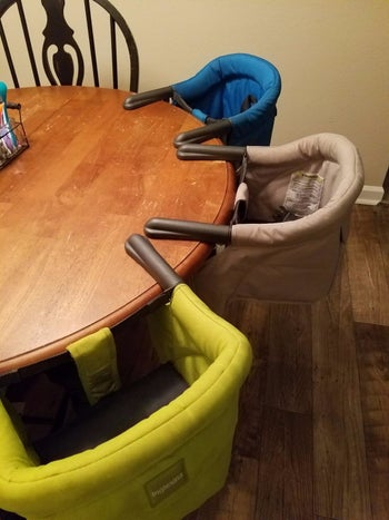 Reviewer's photo of three high chairs attached to their table