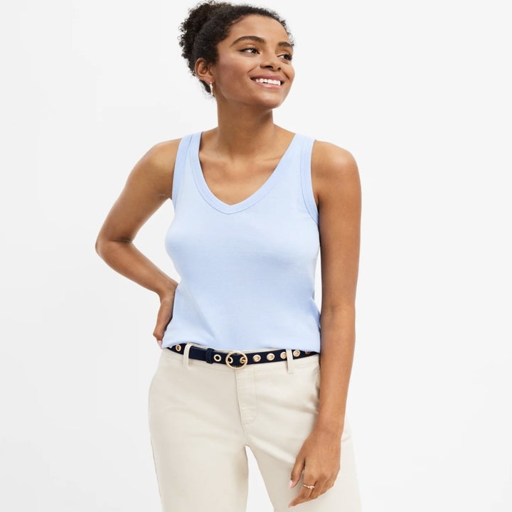 Model wearing the light blue tank with white pants