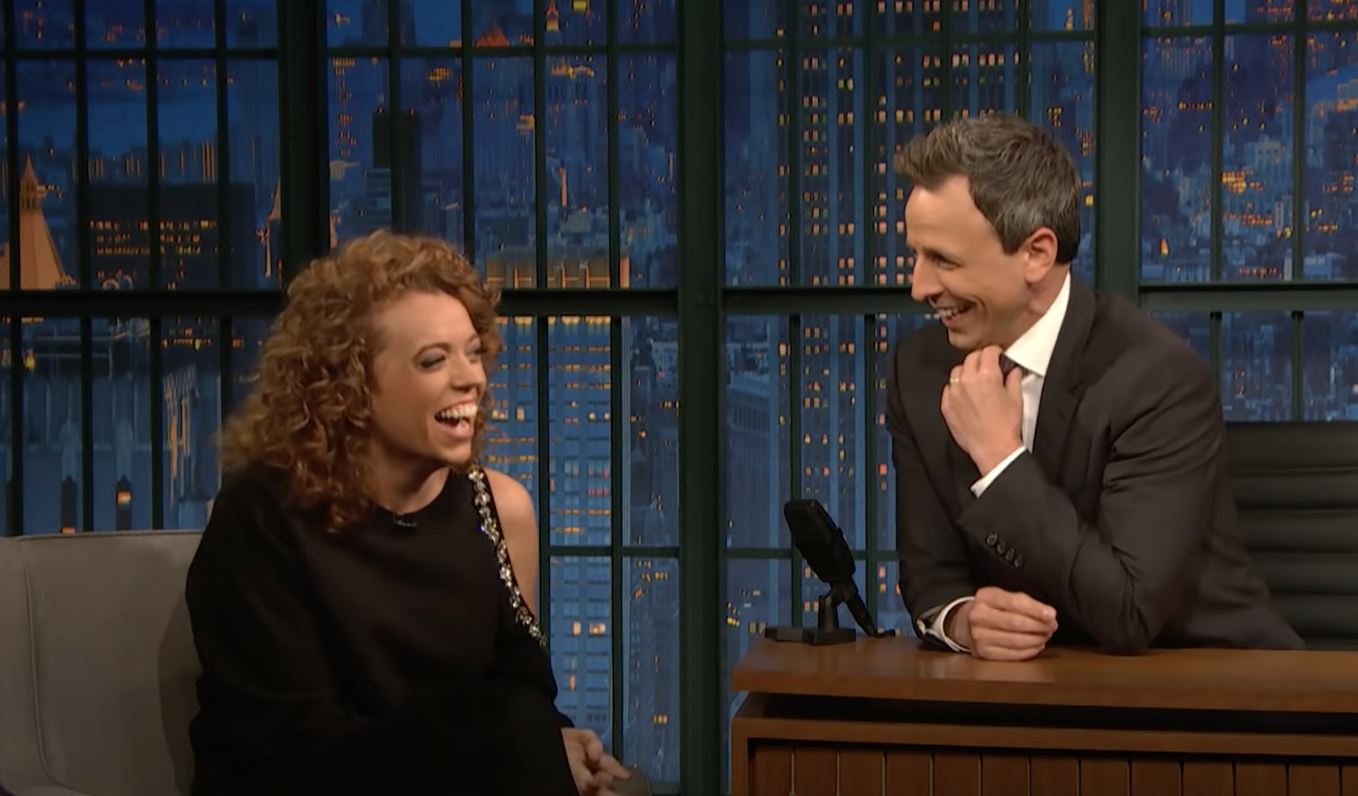 Michelle and Seth Meyers laughing on his talk show
