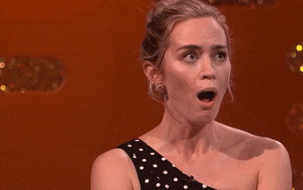 a woman covering her mouth in shock