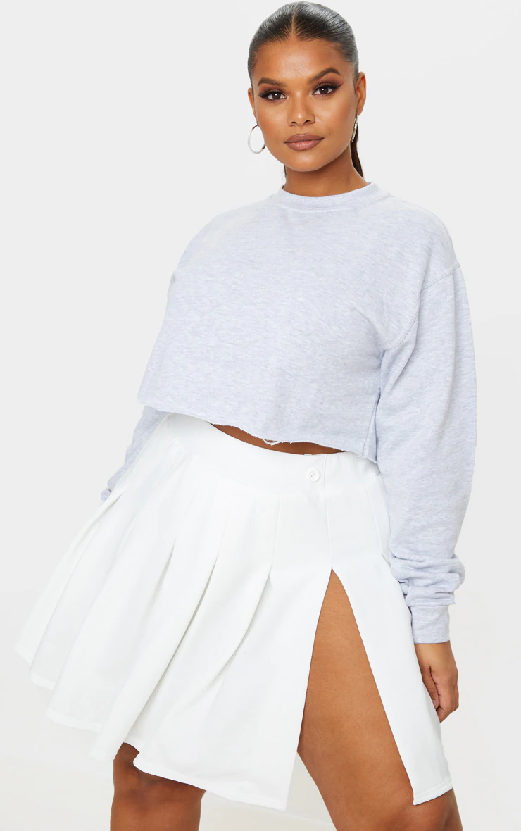 A person wearing the skirt with a cropped sweater