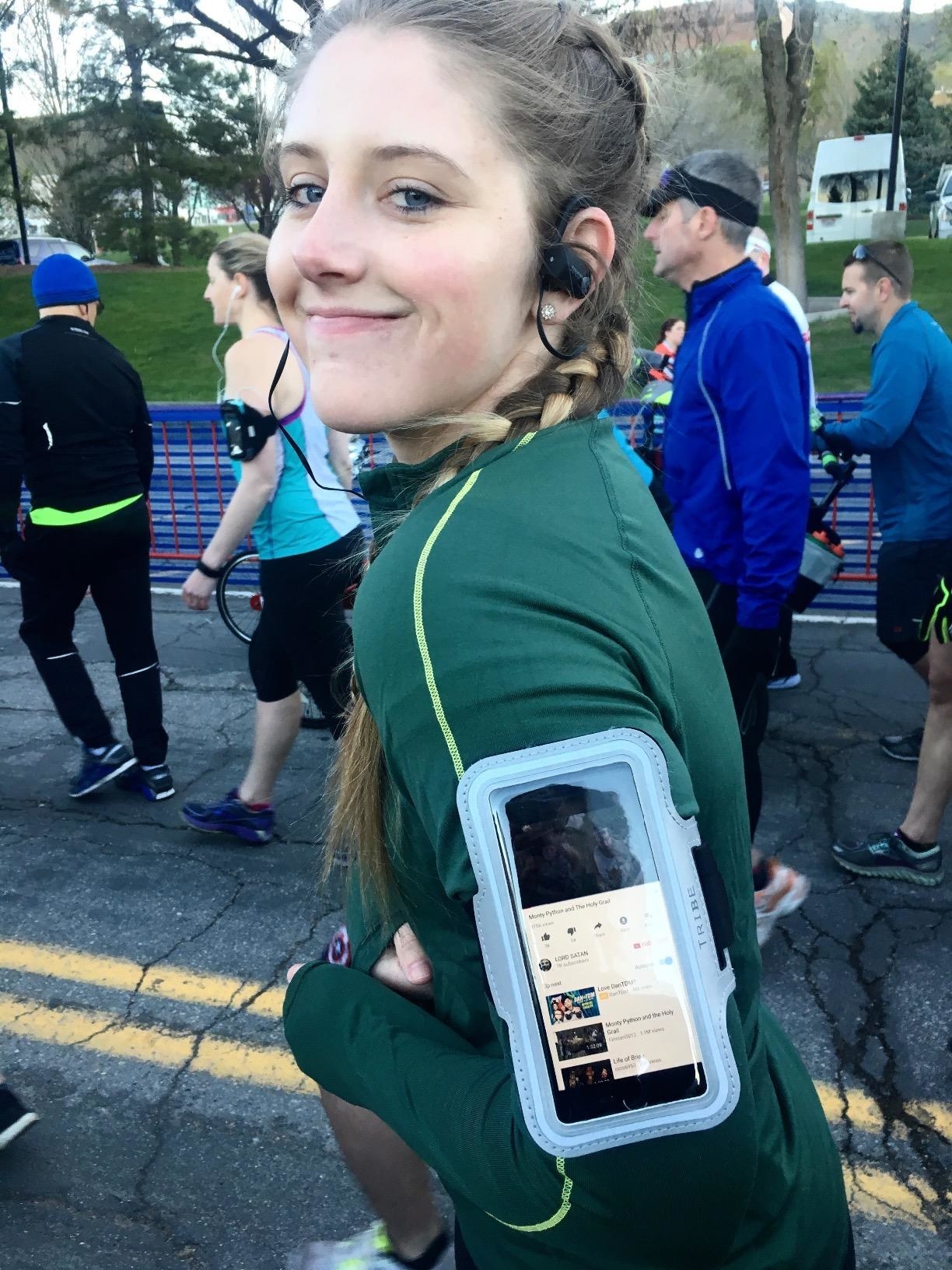 reviewer wears light blue armband with phone inside during half marathon