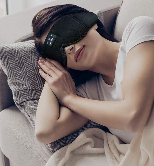 A person wearing the mask while sleeping on a couch
