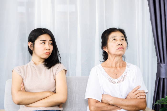 A mom and daughter upset with arms crossed