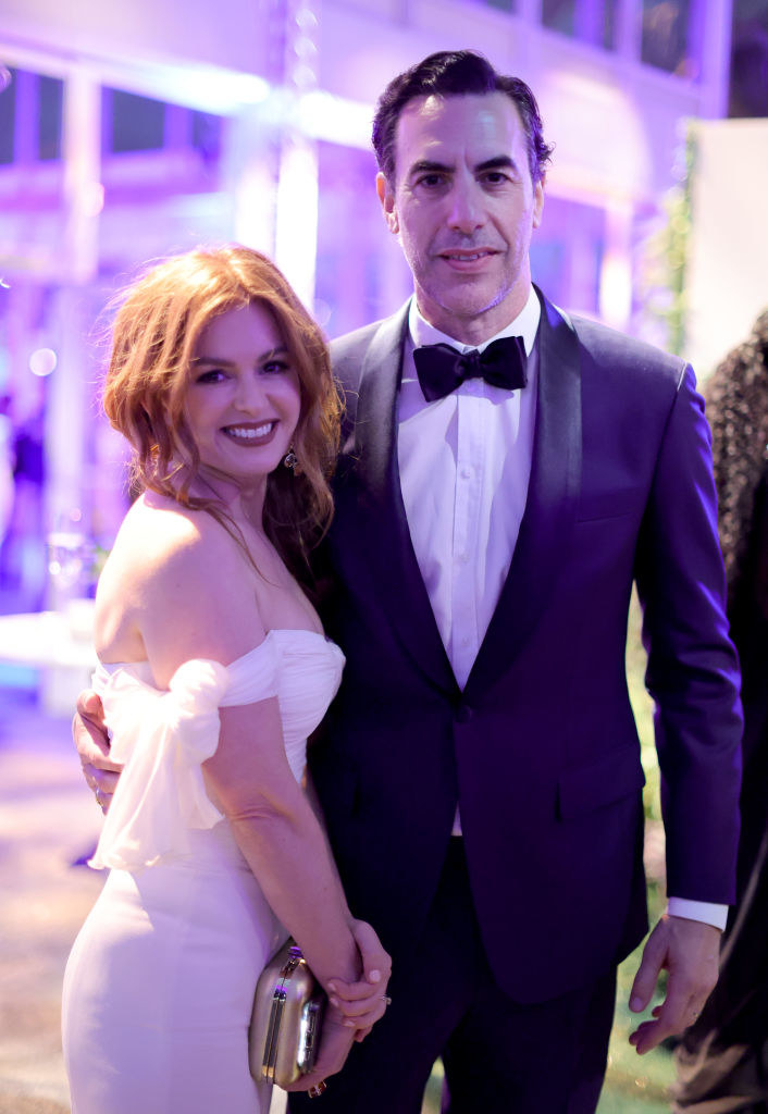 Isla wears an off-the-shoulder dress while Sasha wears a suit for their wedding