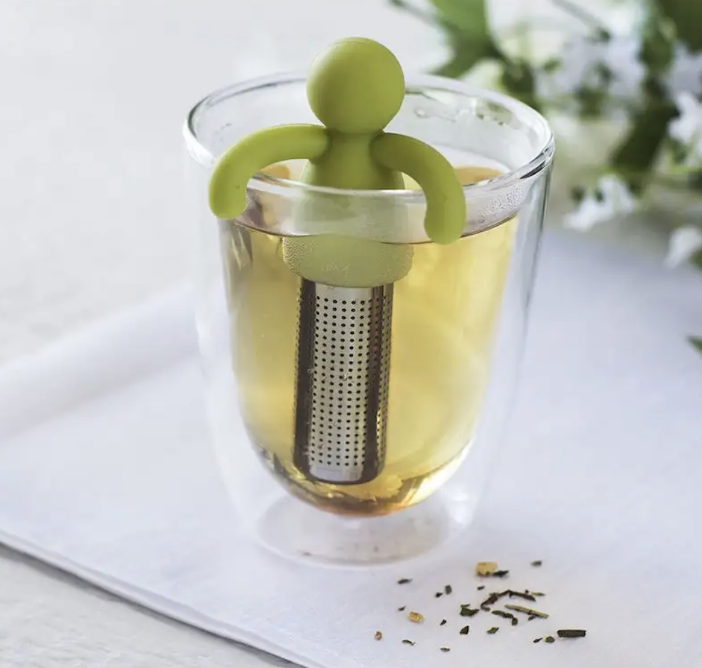 a tea infuser shaped like a person inside of a glass