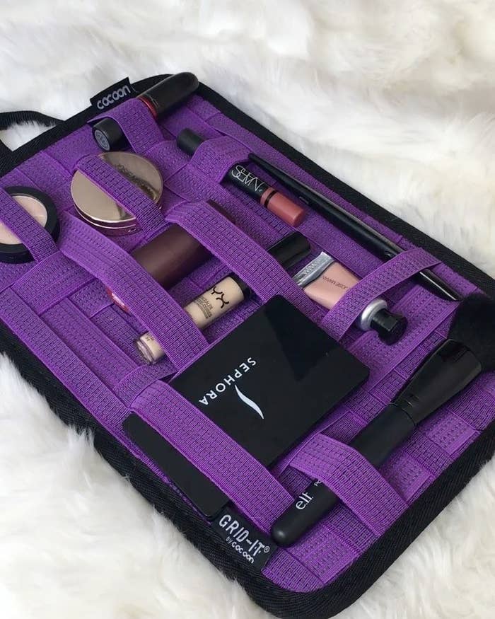 A Grid-It organizer holding makeup tubes and tools in place