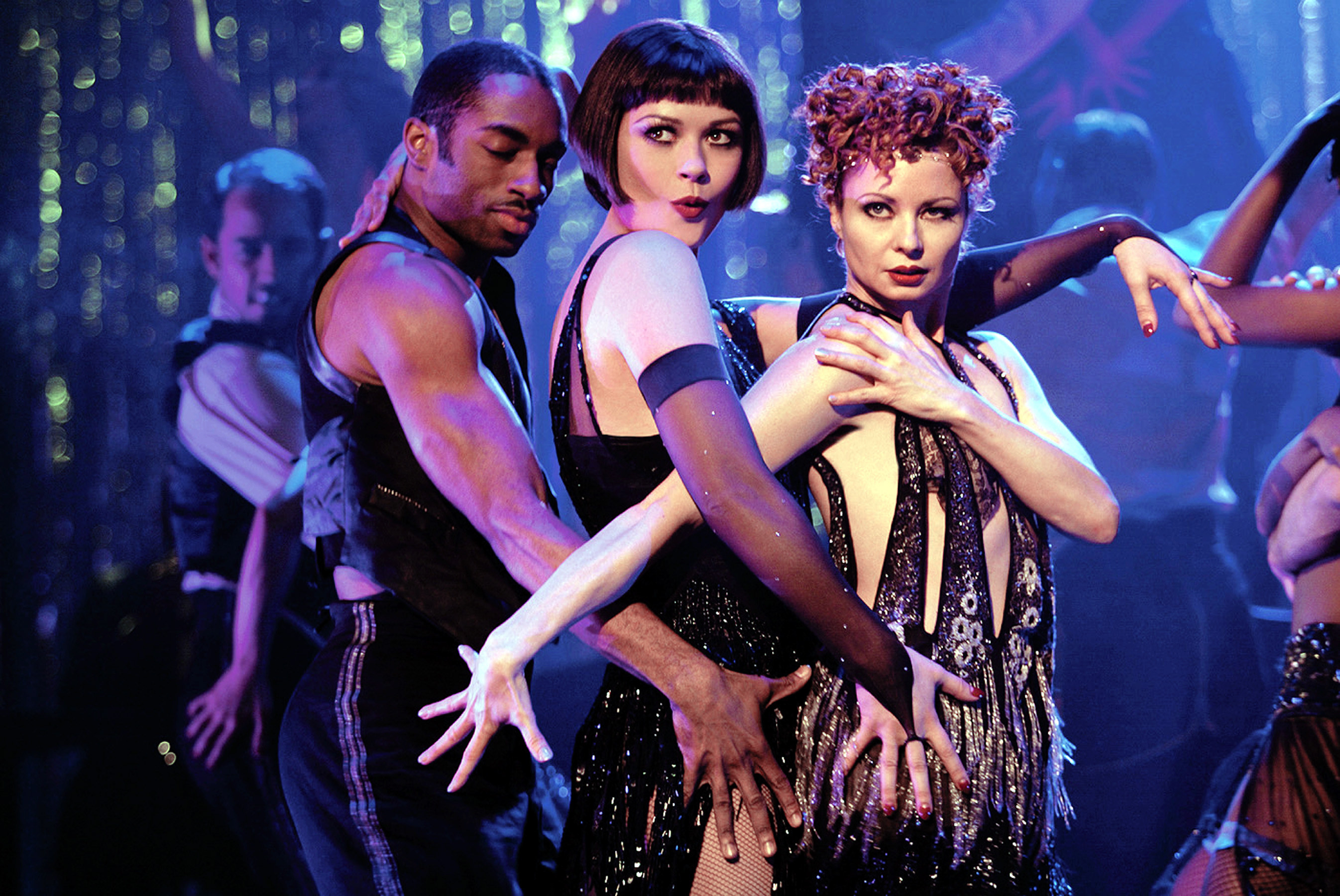 Catherine Zeta-Jones onstage with two dancers