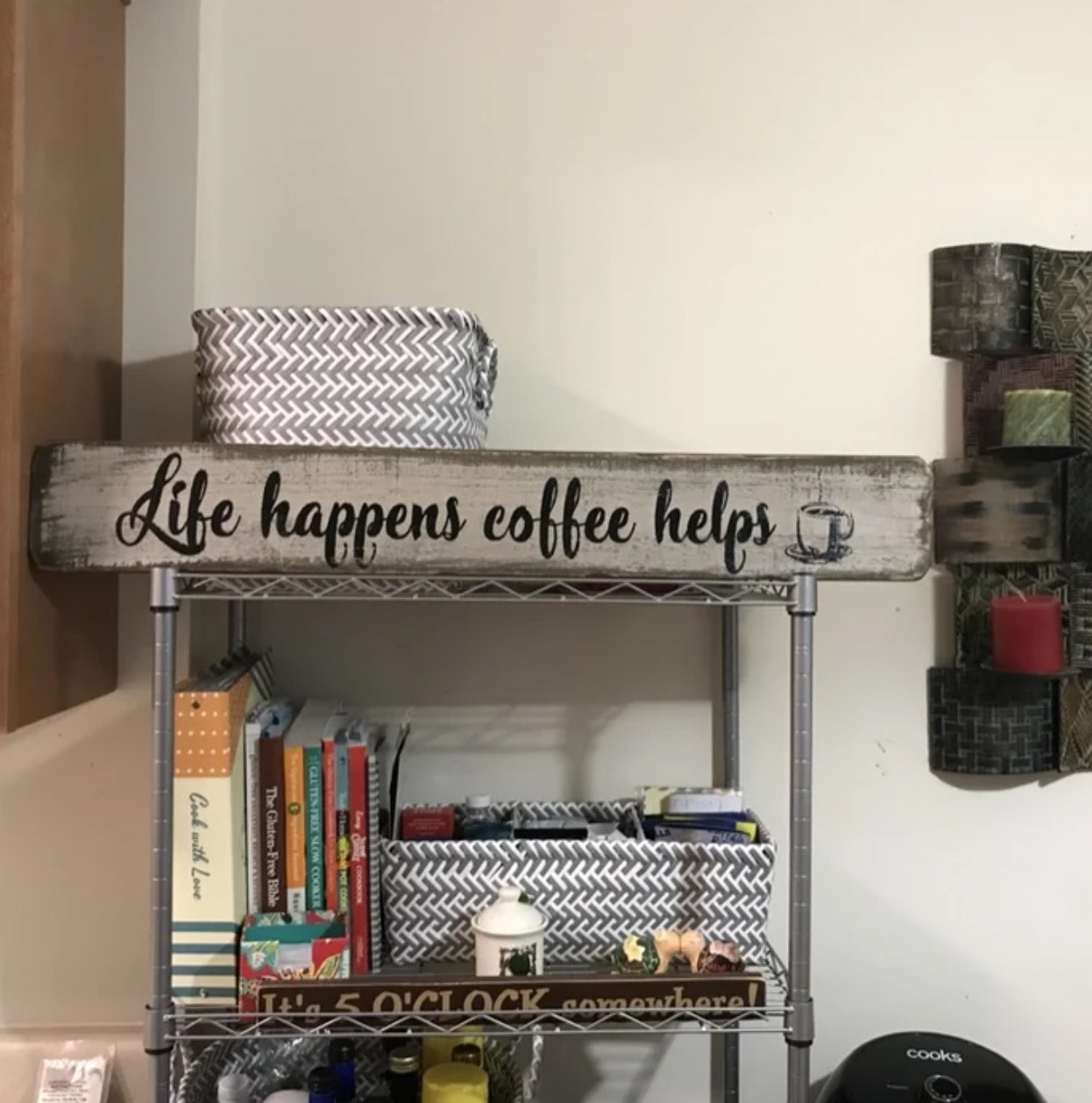 reviewer&#x27;s photo of the sign resting atop a metal storage shelf