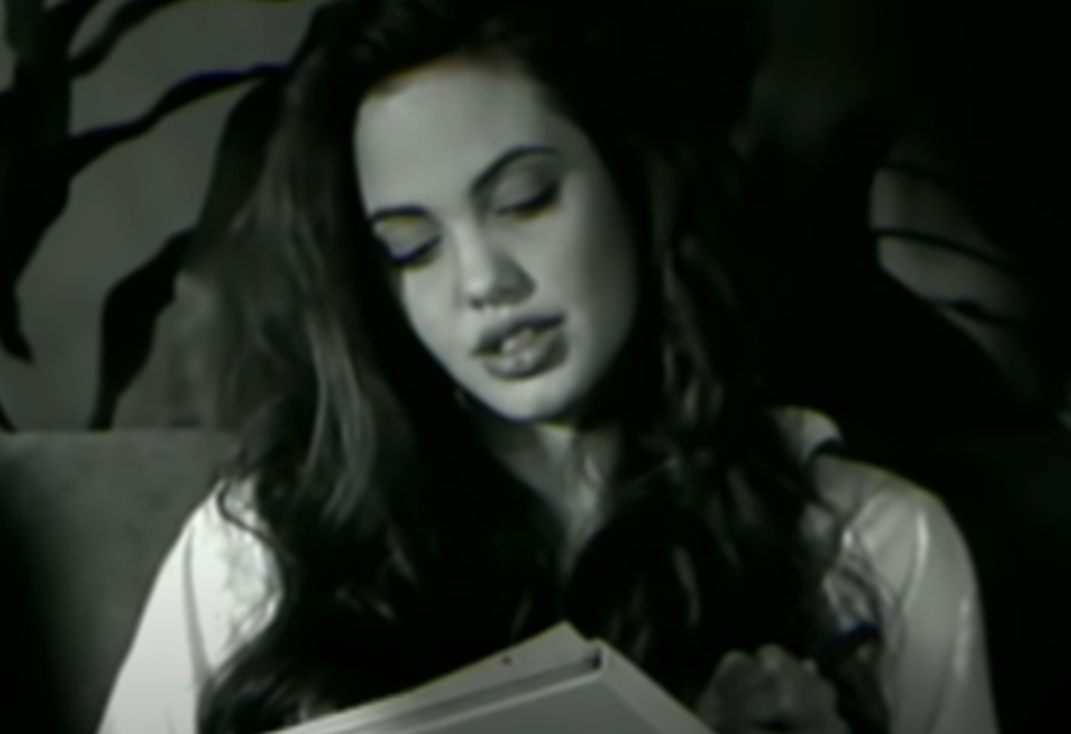 Angelina reading something in the music video