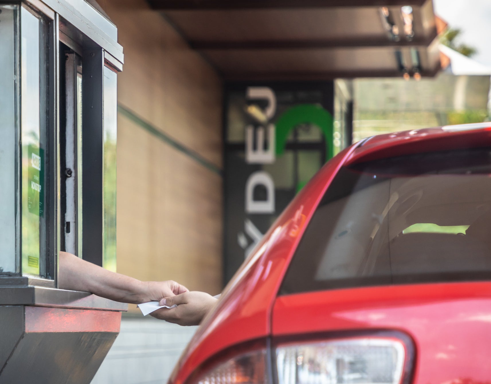 someone paying at the drive thru