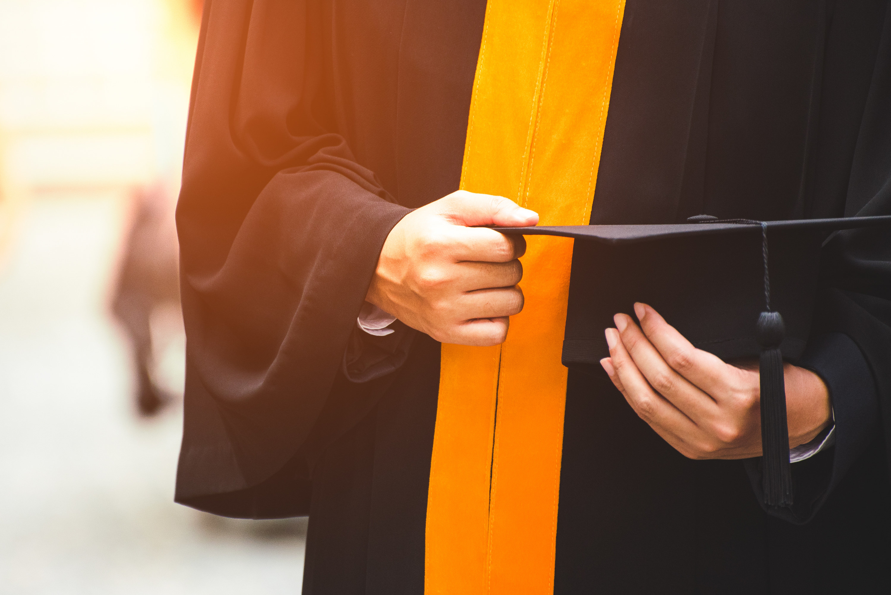 A person in their cap and gown at a graduation