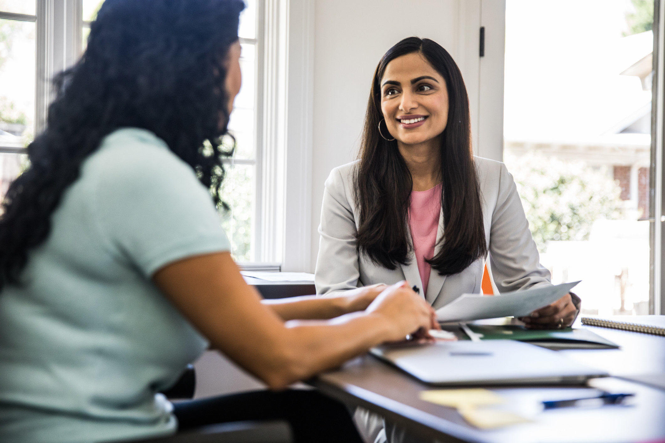 Two women smiling at a job interview