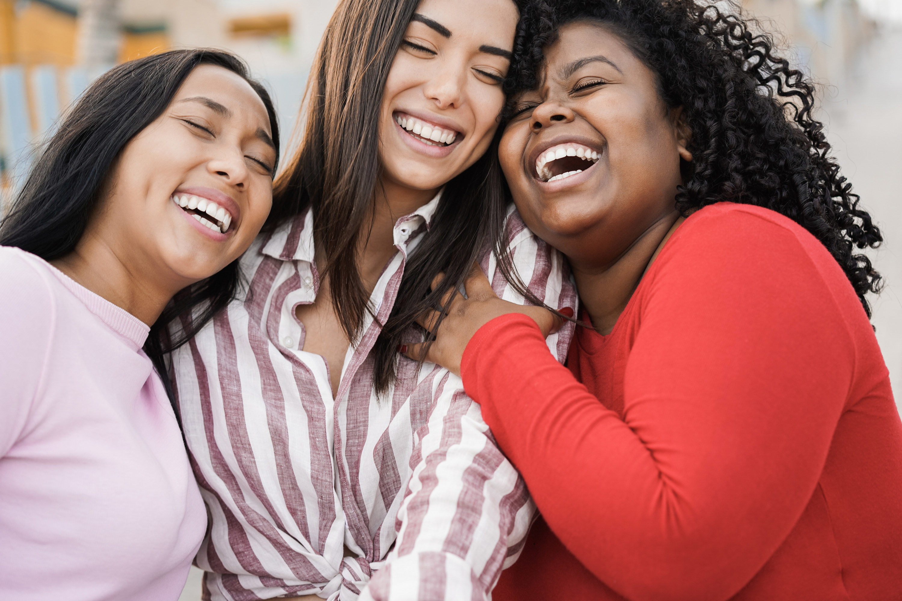 Three female friends laughing together