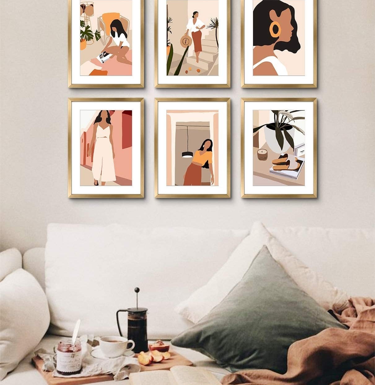The six framed art prints on a wall above a couch