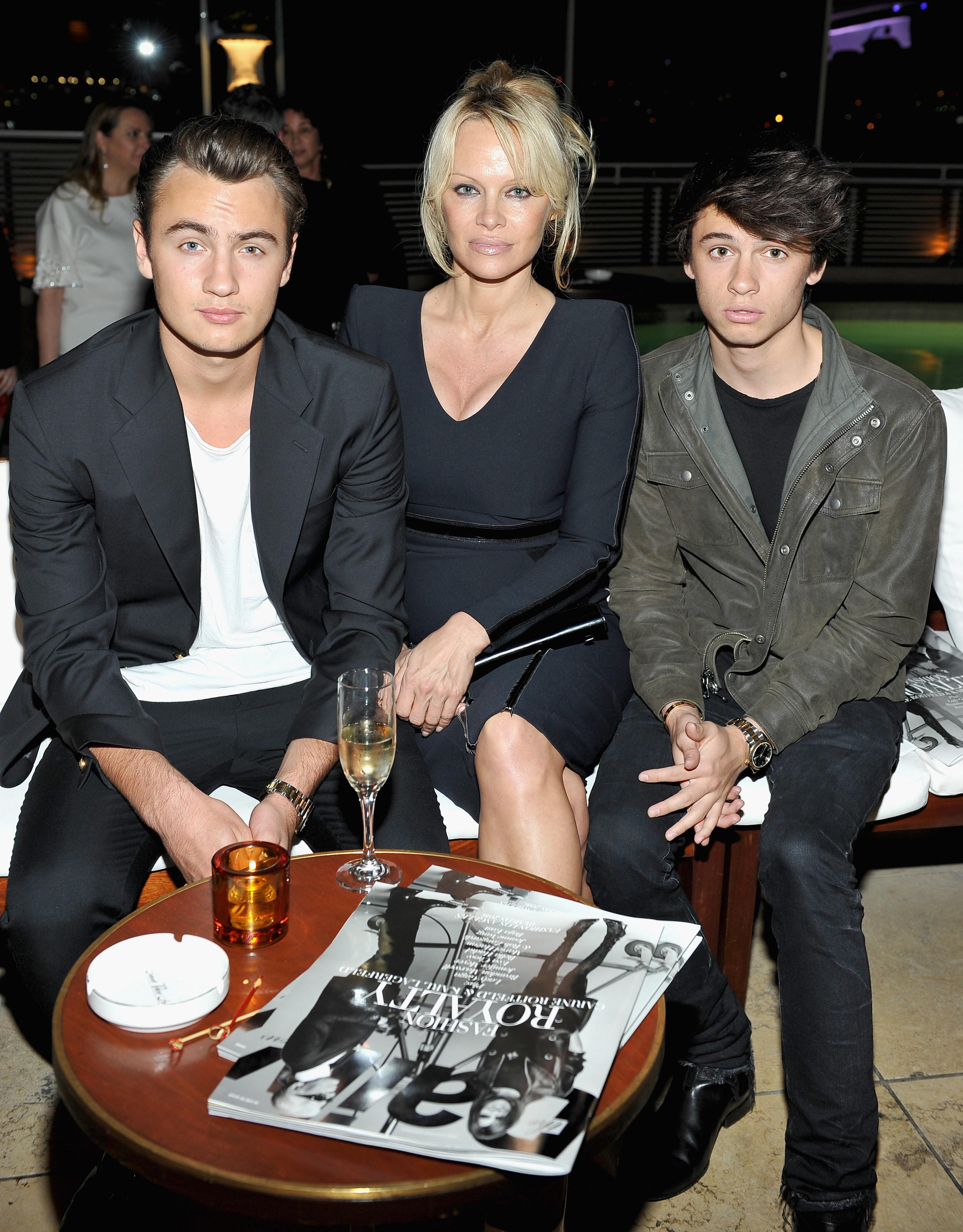 Pamela Anderson sits with her sons, Brandon and Dylan, at The Daily Front Row &quot;Fashion Los Angeles Awards&quot; in 2016