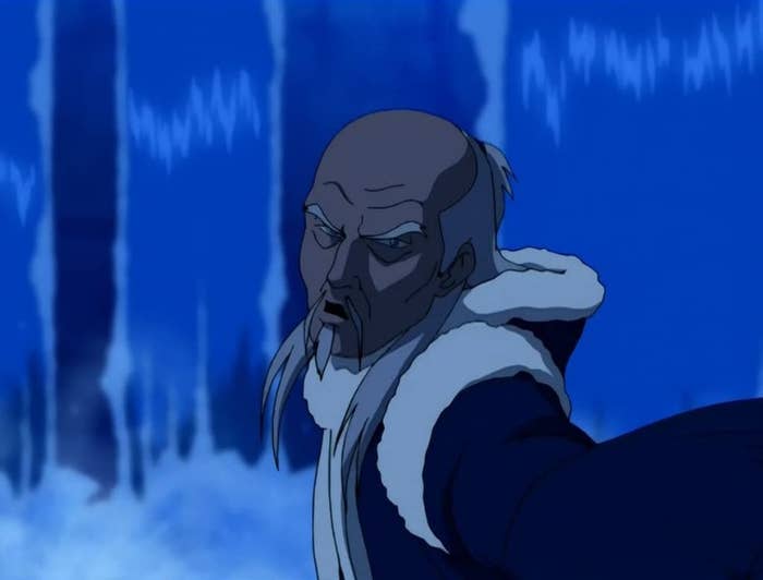 master pakku in front of a freezing water fountain. he is bald with wrinkles on his forehead, furrowed brows, thin beard