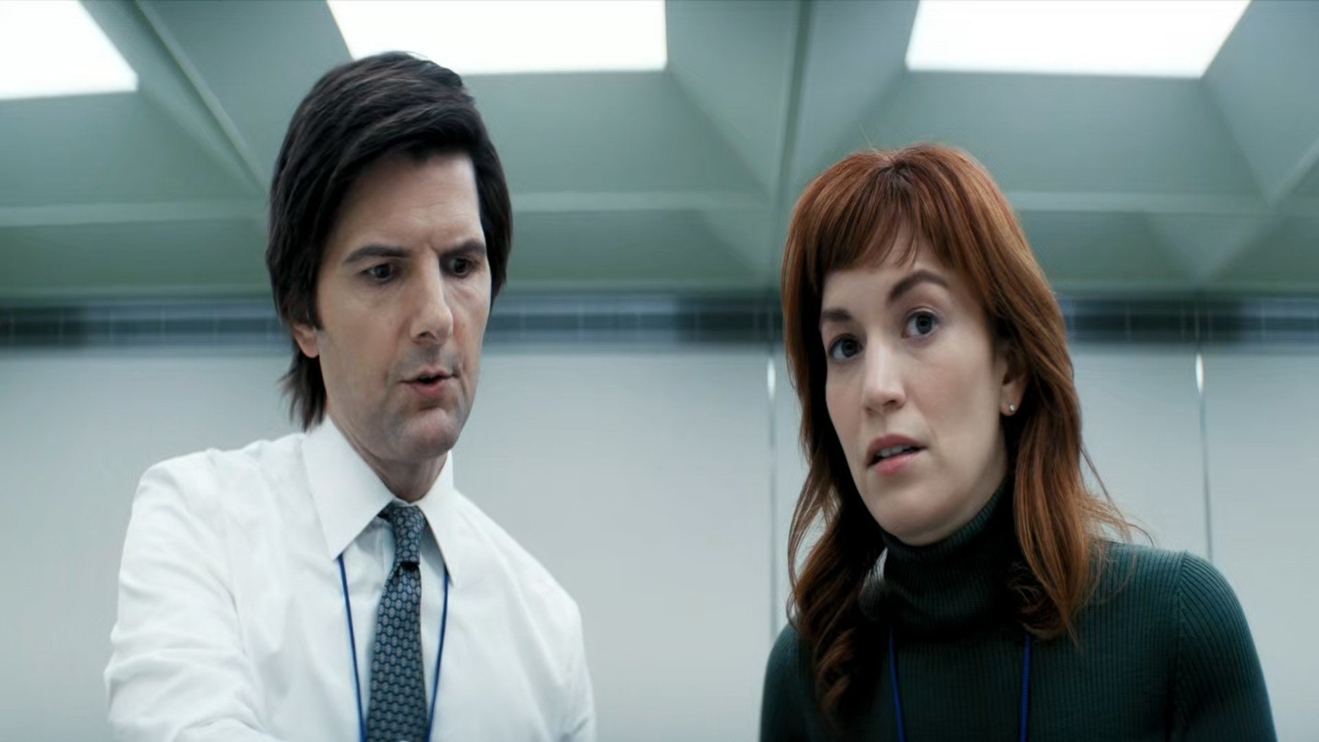 Britt Lower and Adam Scott look at something