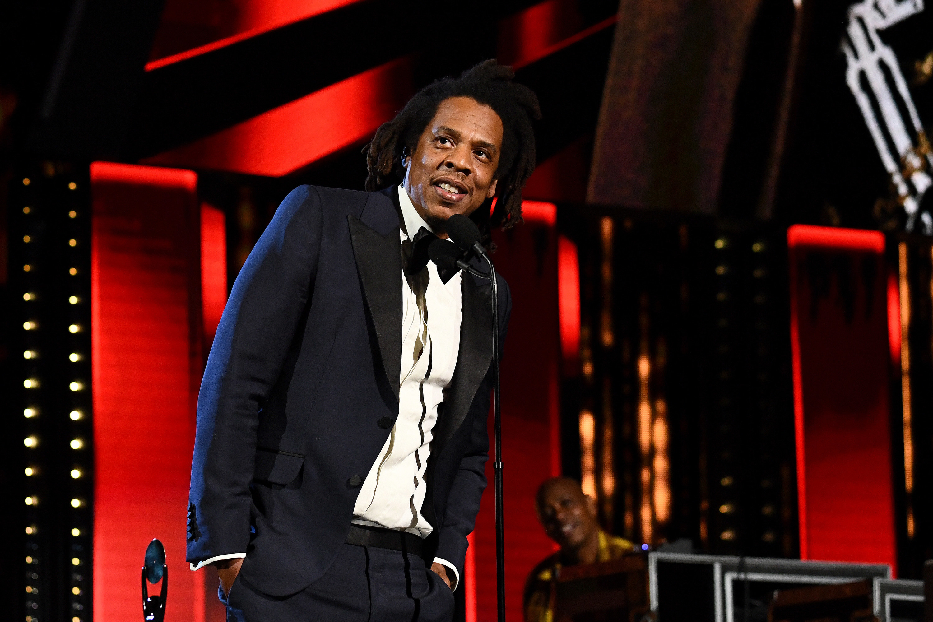 Jay-Z in a tuxedo, smiling