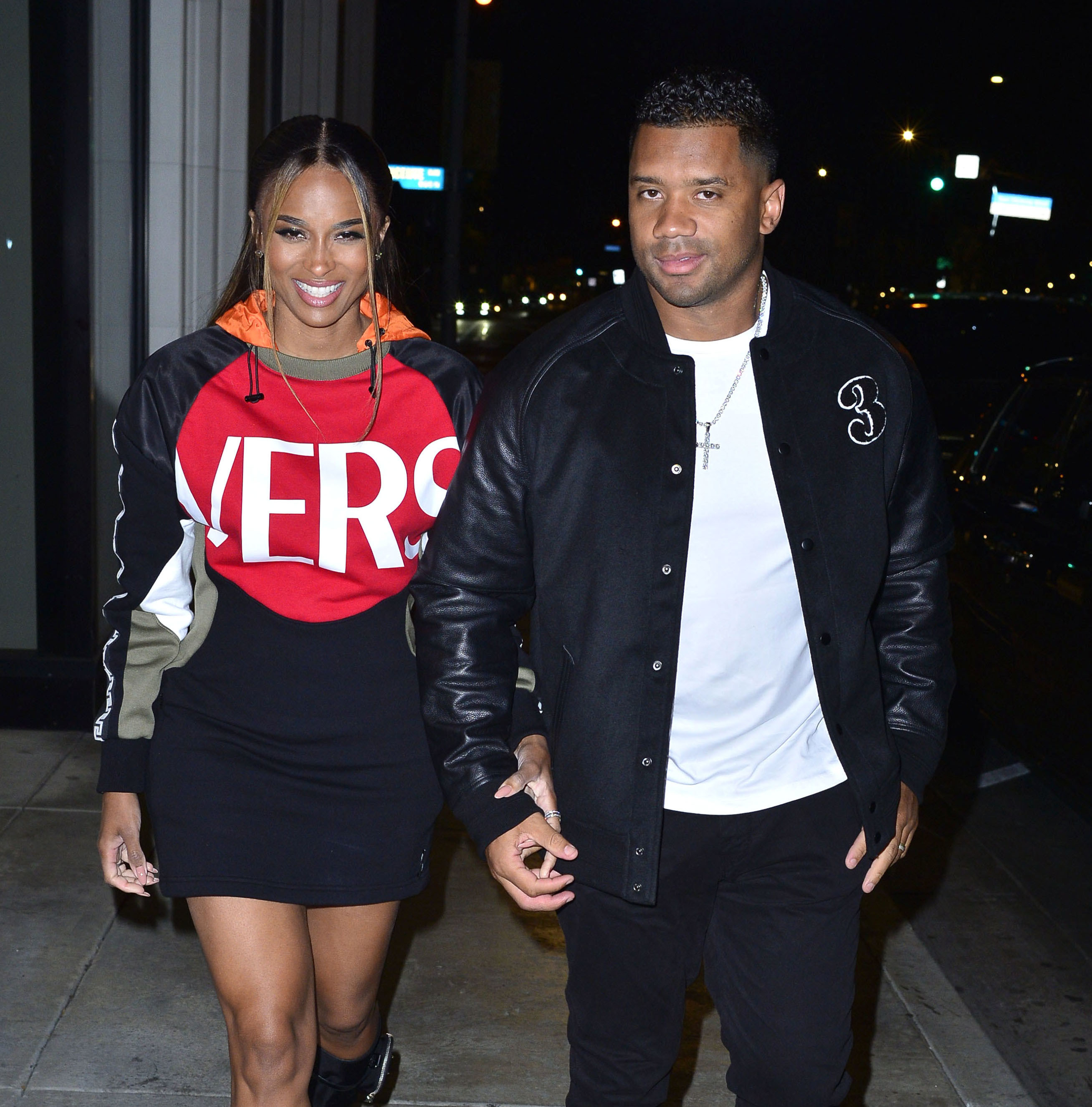 Russell and Ciara walk down the street together