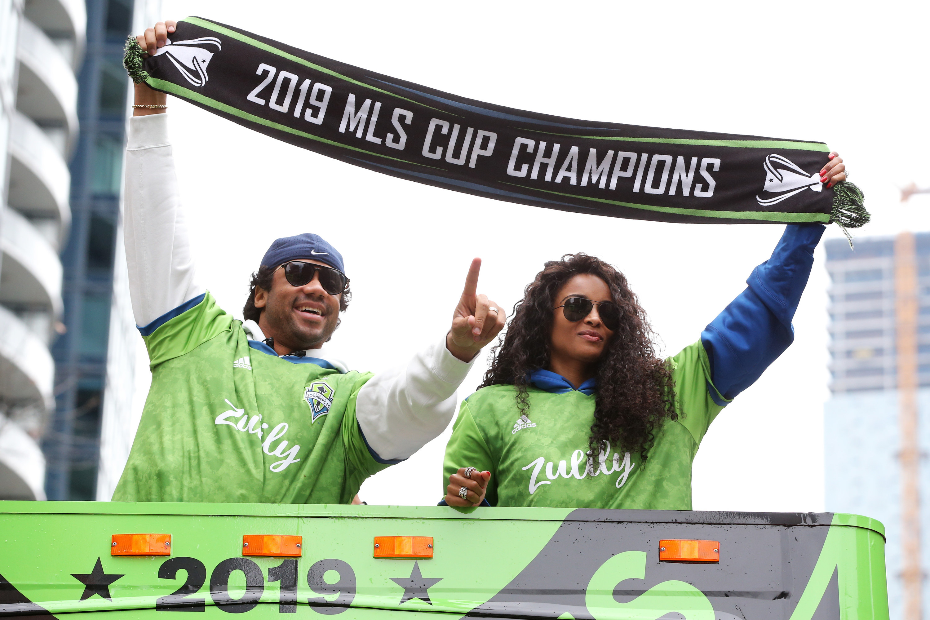 Russell and Ciara hold up an MLS Cup banner