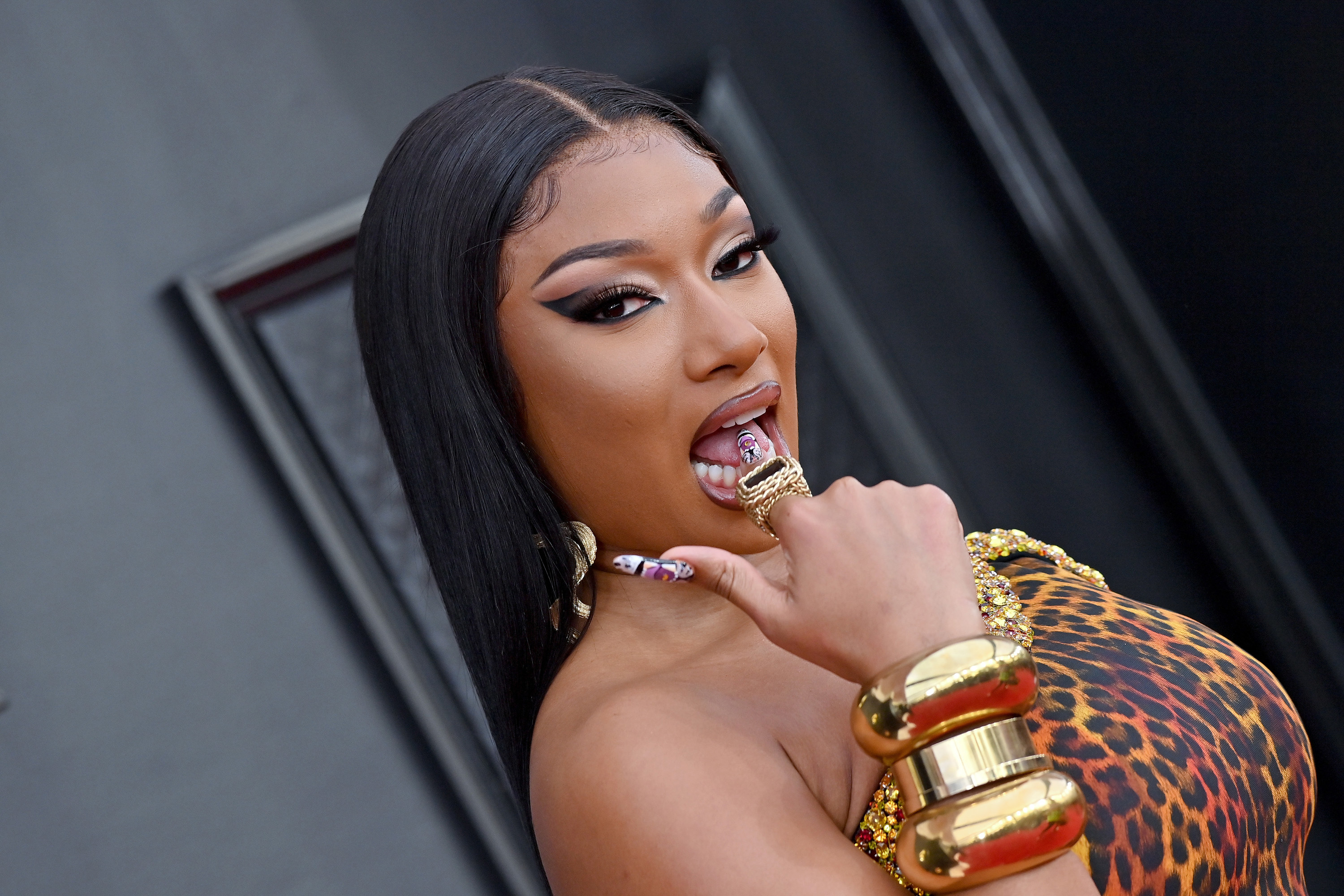 Megan Thee Stallion putting her finger on her tongue