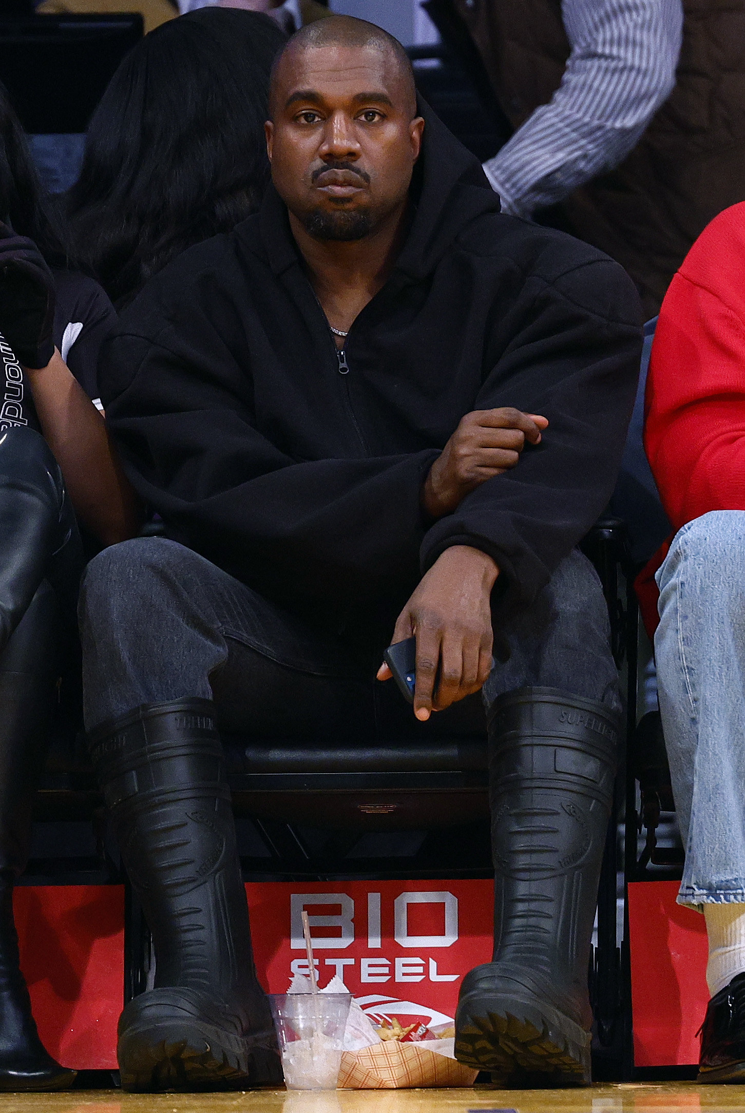 Kanye West at a game looking straight at the camera