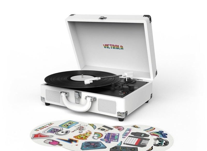 white canvas victrola record player next to stickers