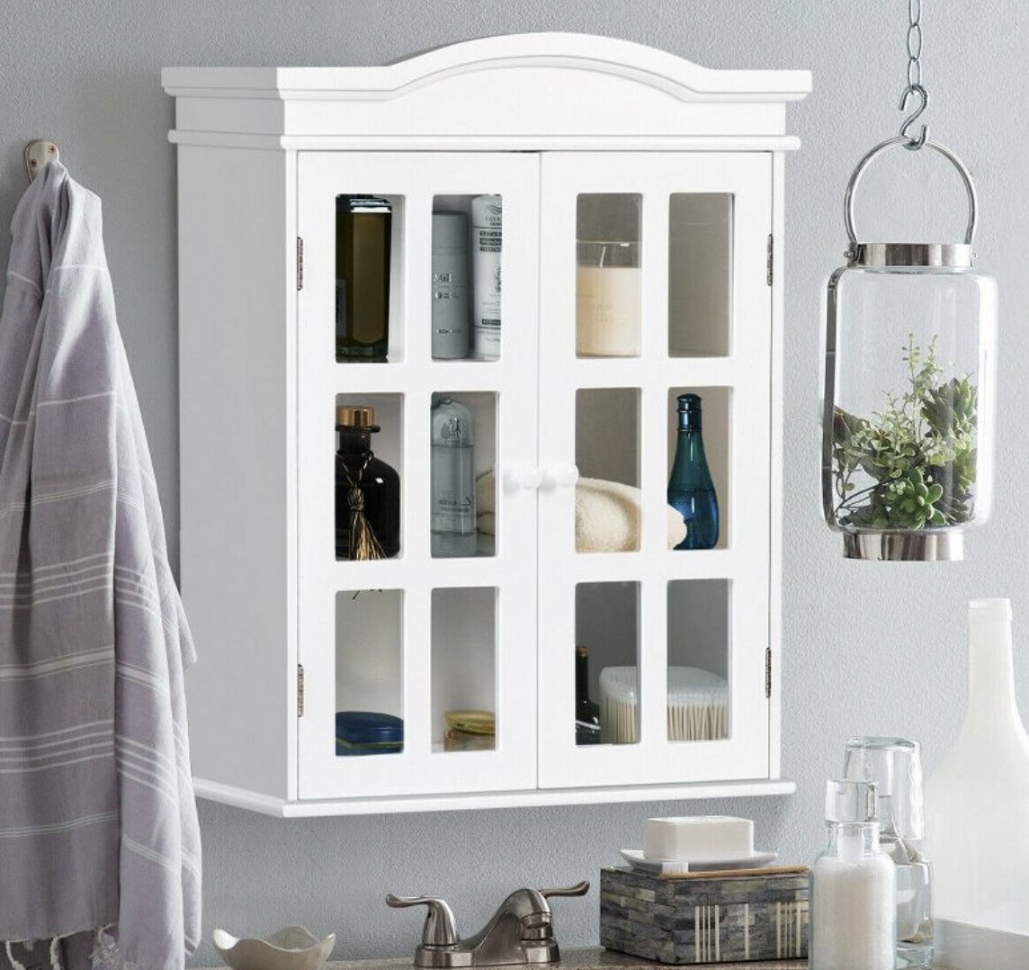 A white wall-mount storage cabinet with transparent door panels