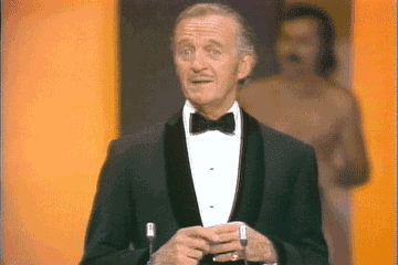 A streaker running past David Niven onstage at the Oscars