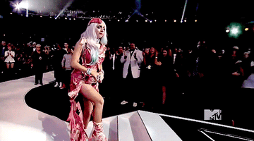 Lady Gaga walks up the VMA stage steps wearing her meat dress