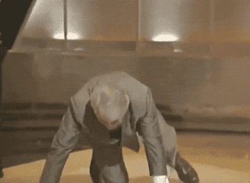 Actor Jack Palance does one-armed pushups on stage at the Oscars