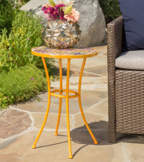 A bright orange metal side table with round-tiled top and 4 legs.