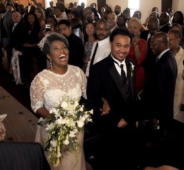 Kellie Shanygne Williams smiles as she walks down the aisle with Hannibal Jackson