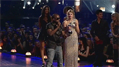 Kanye West giving the mic back to Taylor Swift after stealing it from her