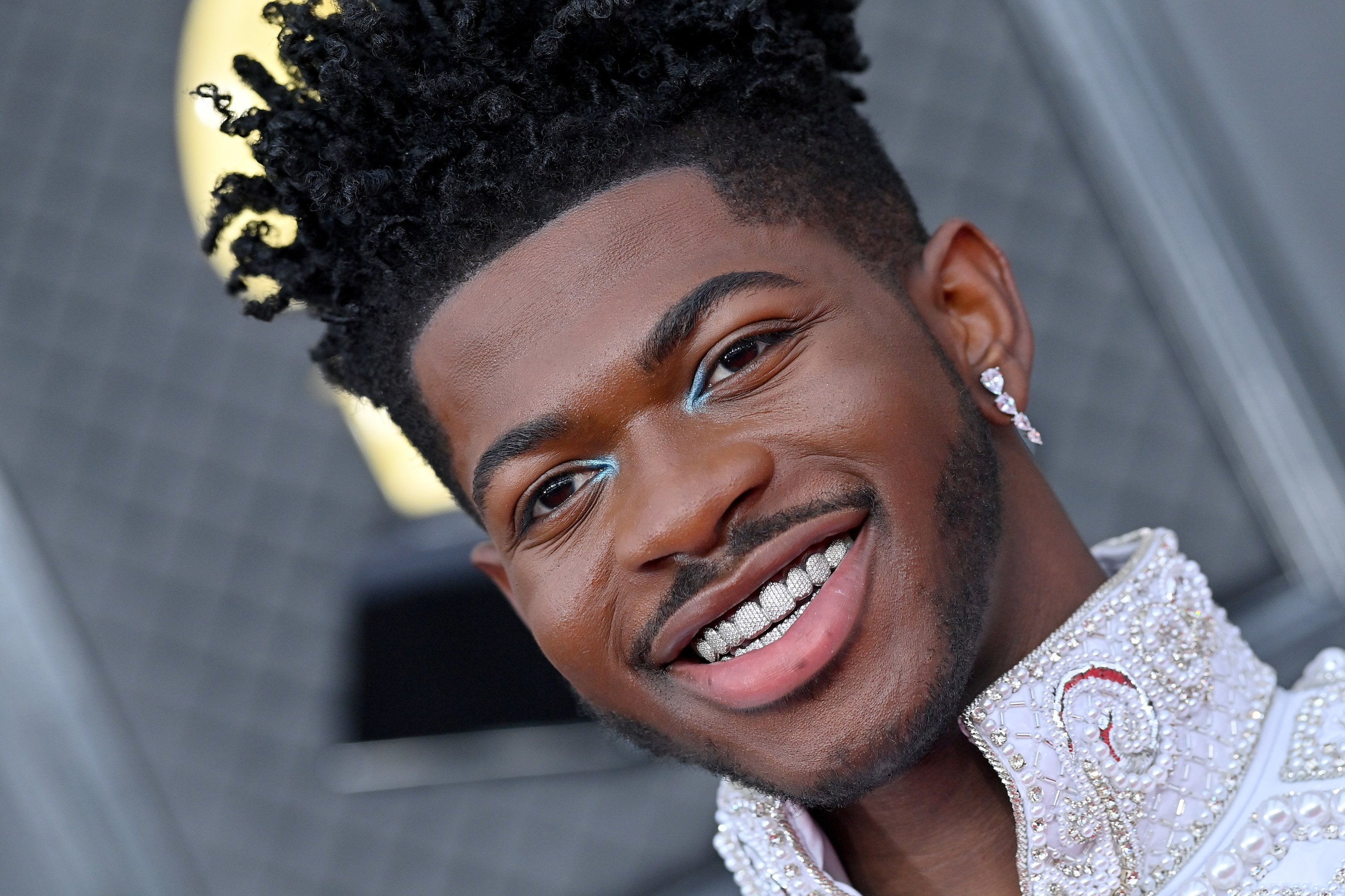 Lil Nas X smiling at the 2022 Grammys.