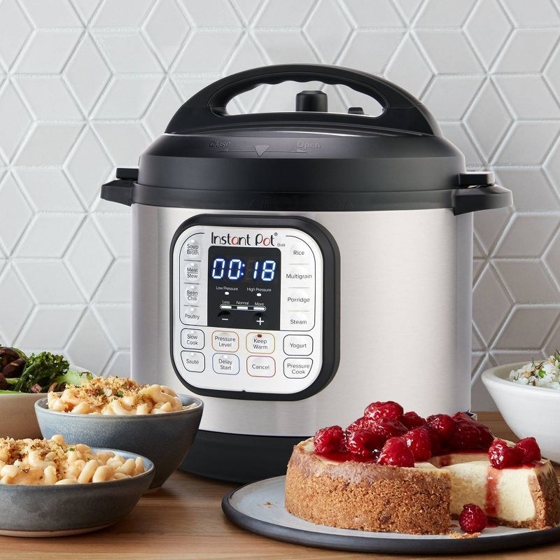 The Instant Pot sits on the counter in front of foods that are easily made in it